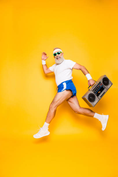 dreamy cheerful excited sporty aged funny sexy grandpa in eyewear with recorder in hand. old school, swag, fooling qround, gym, technology, success, hip hop, chill, party, leisure - retro revival fun caucasian one person imagens e fotografias de stock