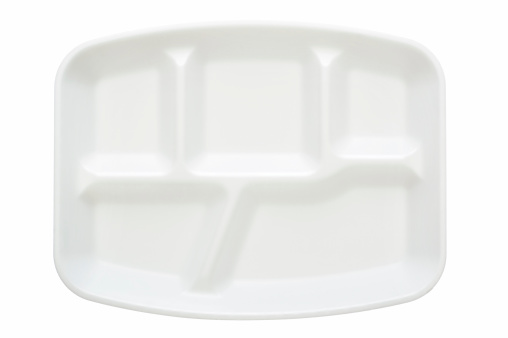 A disposable styrofoam plate, isolated on white.