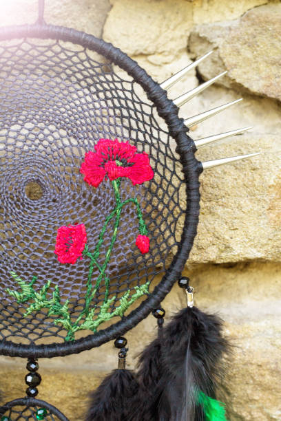 istock Handmade dream catcher with feathers threads and beads rope hanging 928905456