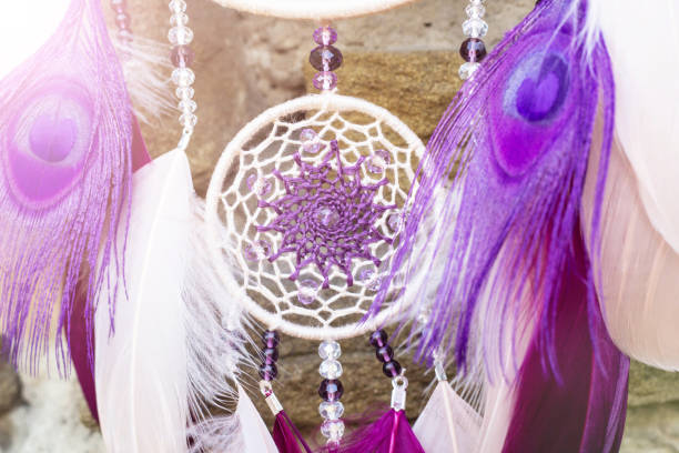 istock Handmade dream catcher with feathers threads and beads rope hanging 928905468