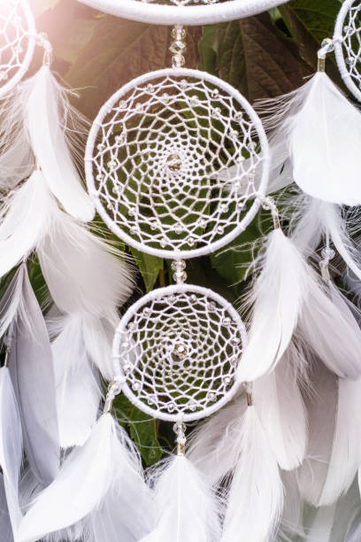 istock Handmade dream catcher with feathers threads and beads rope hanging 928905532