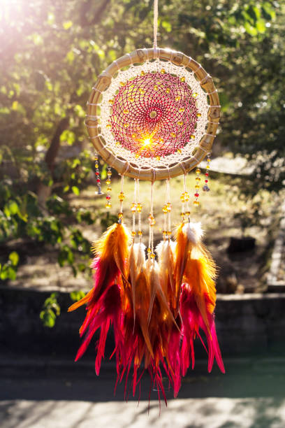 istock Handmade dream catcher with feathers threads and beads rope hanging 928905574