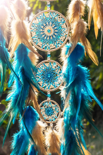 istock Handmade dream catcher with feathers threads and beads rope hanging 928905588