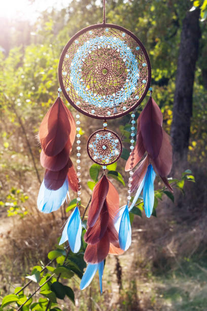 istock Handmade dream catcher with feathers threads and beads rope hanging 928905606