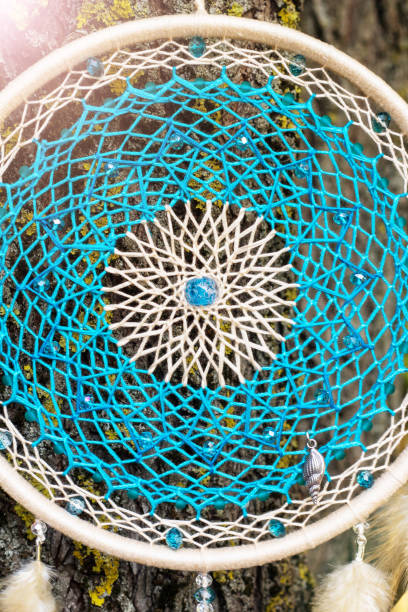 istock Handmade dream catcher with feathers threads and beads rope hanging 928905614