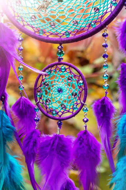 istock Handmade dream catcher with feathers threads and beads rope hanging 928905646