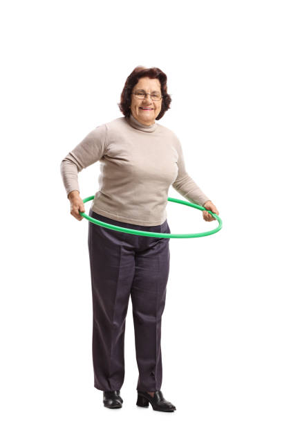 istock Elderly woman with a hula-hoop 928905776