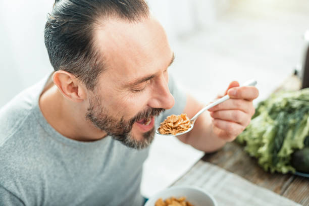 istock Funny pleasant man opening mouth and eating 928905840