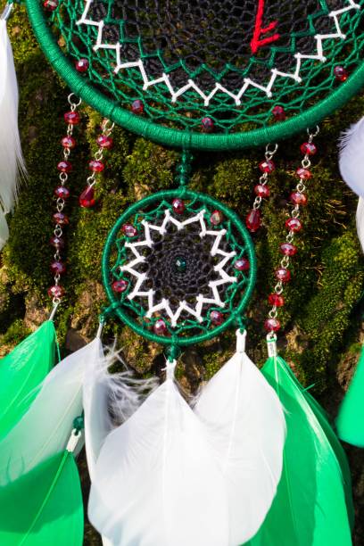 istock Handmade dream catcher with feathers threads and beads rope hanging 928910056