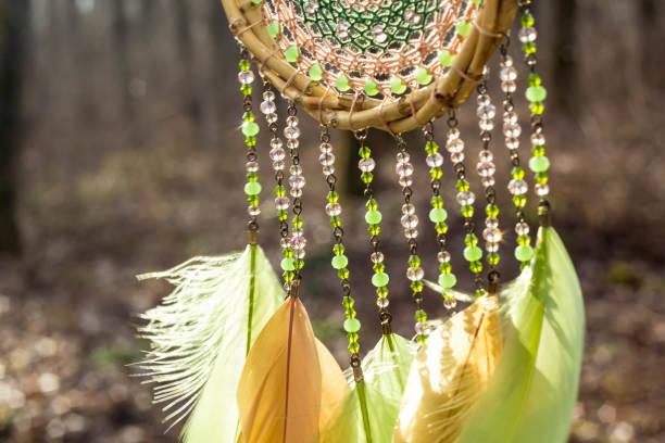 istock Handmade dream catcher with feathers threads and beads rope hanging 928910200