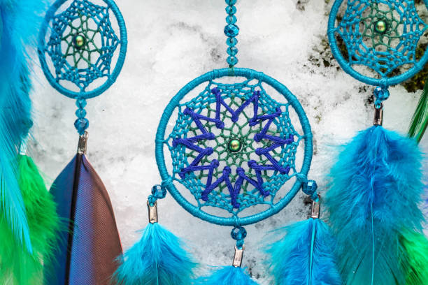 istock Handmade dream catcher with feathers threads and beads rope hanging 928910382