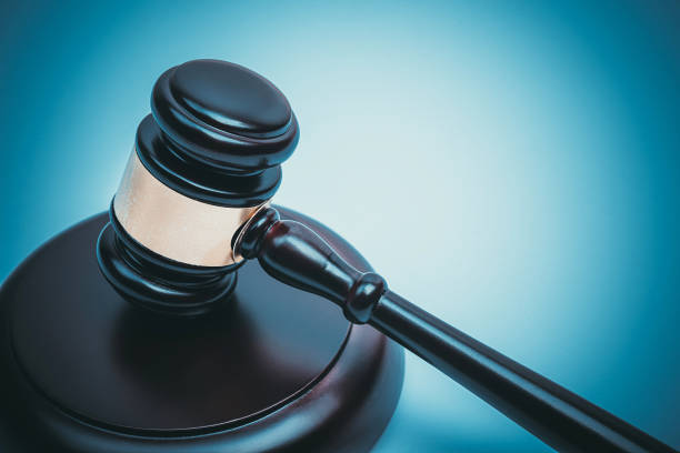 istock Black Judge Wood Hammer with blue background 928913070