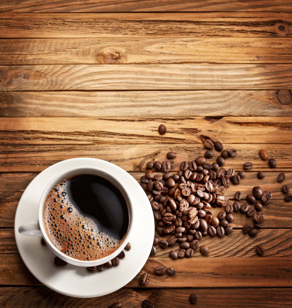 istock Cup of coffee on the wooden table. 928913370