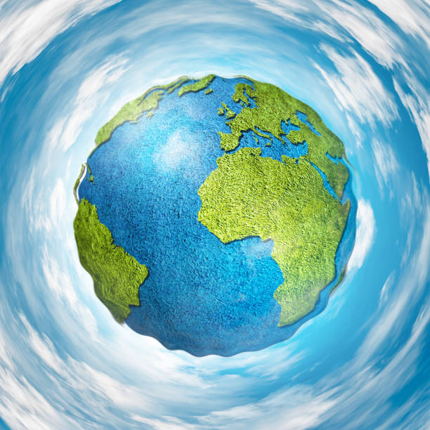 istock Grass covered globe with world map surrounded with clouds and blue sky 928913748