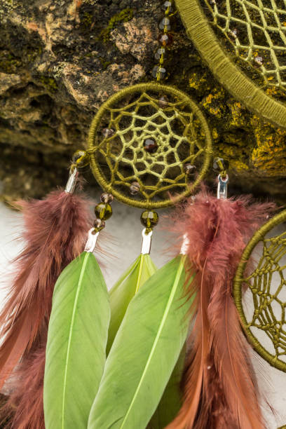 istock Handmade dream catcher with feathers threads and beads rope hanging 928917080