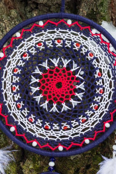 istock Handmade dream catcher with feathers threads and beads rope hanging 928917264
