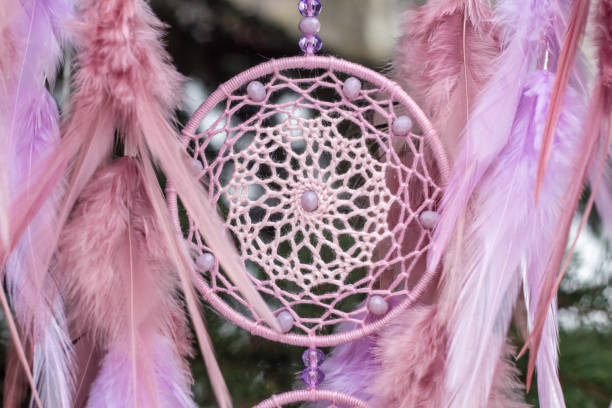 istock Handmade dream catcher with feathers threads and beads rope hanging 928917364