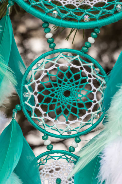 istock Handmade dream catcher with feathers threads and beads rope hanging 928917442