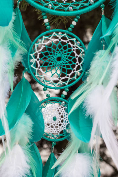 istock Handmade dream catcher with feathers threads and beads rope hanging 928917444