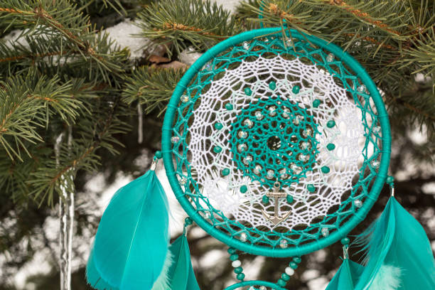 istock Handmade dream catcher with feathers threads and beads rope hanging 928917460