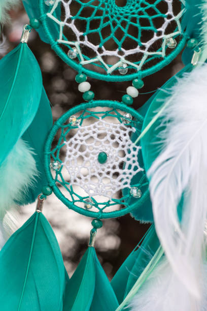 istock Handmade dream catcher with feathers threads and beads rope hanging 928917474