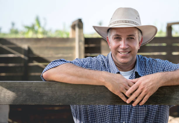 istock Happy man working at a horse farm 928917556