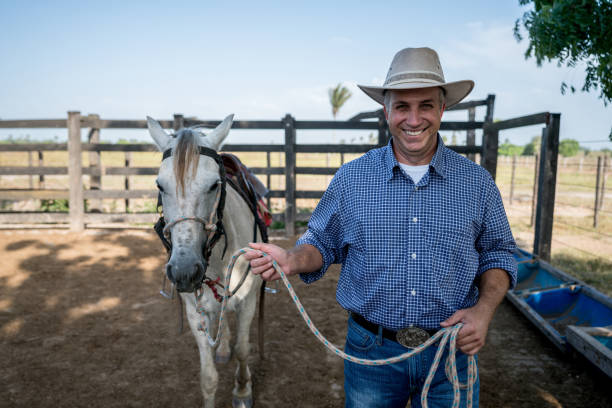 istock Happy man going horseback riding at a farm 928917682
