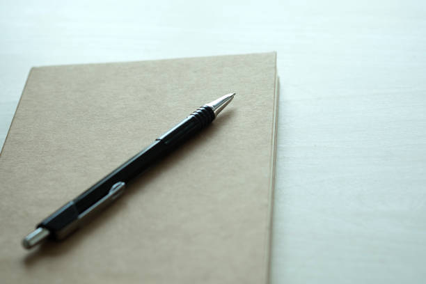 istock Top view of businessman  blank notebook business document black pen 928925178