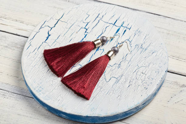 istock Red tassel earrings on white background 928925808