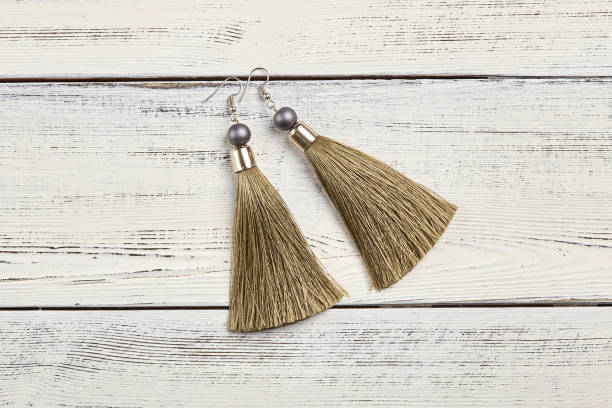 istock Beige tassel earrings on white background 928925858