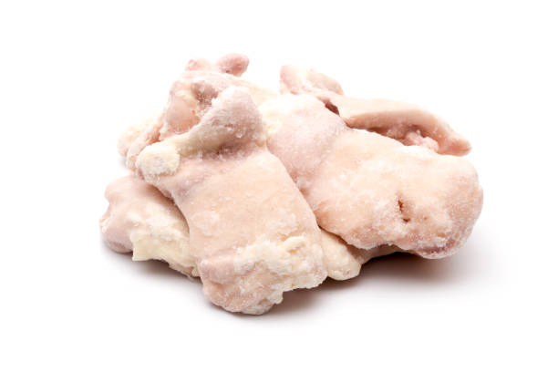 istock Raw Frozen Chicken Thighs on a White Background 928926036