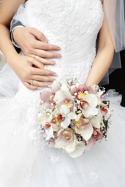 istock bride and groom hands with wedding rings 92892901