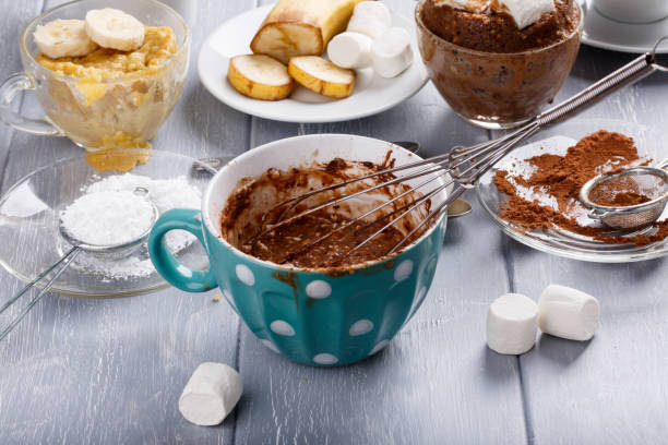 Quick chocolate cake with marshmallow in a glass mug from microwave. Cooking.