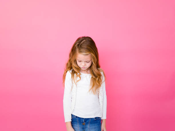istock Sad Girl Standing Against Pink Background 928930666