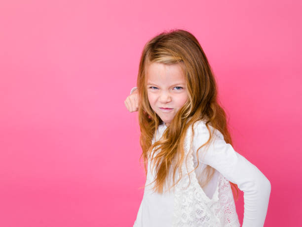 istock Angry Girl Against Pink Background 928930772