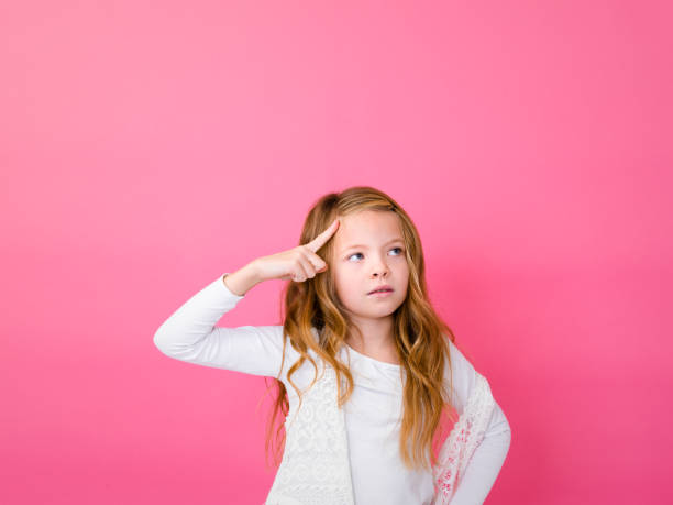 istock Thoughtful Girl Against Pink Background 928930936