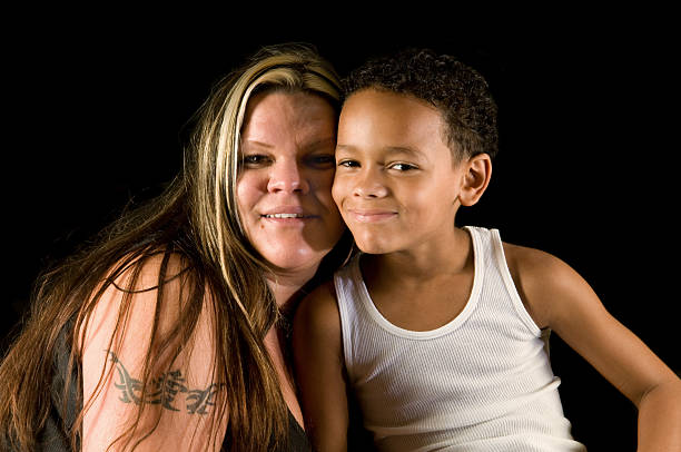 Caucasian mother with her mixed race seven year old son,being close, smiling.