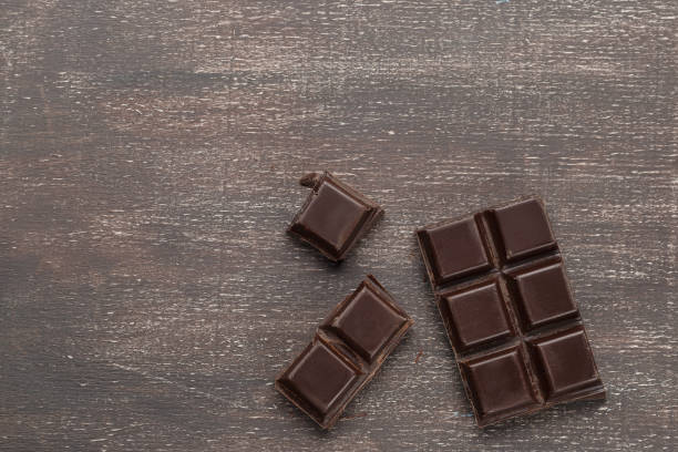 istock Dark chocolate bar on a wooden table 928937932