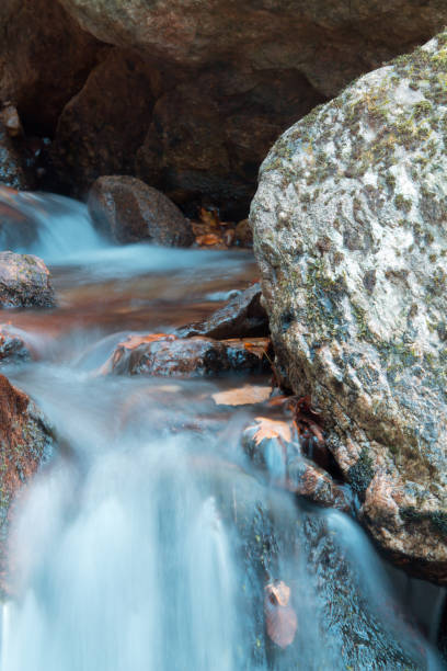 istock beautiful forest river waterfall with rocks in long exposure 928944824