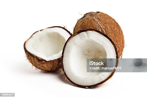 Coconut Cracked Open With A Whole Coconut On White Back Stock Photo - Download Image Now