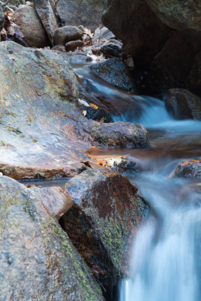 istock beautiful forest river waterfall with rocks in long exposure 928951480