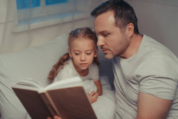 istock family reading book at bedtime 928953534
