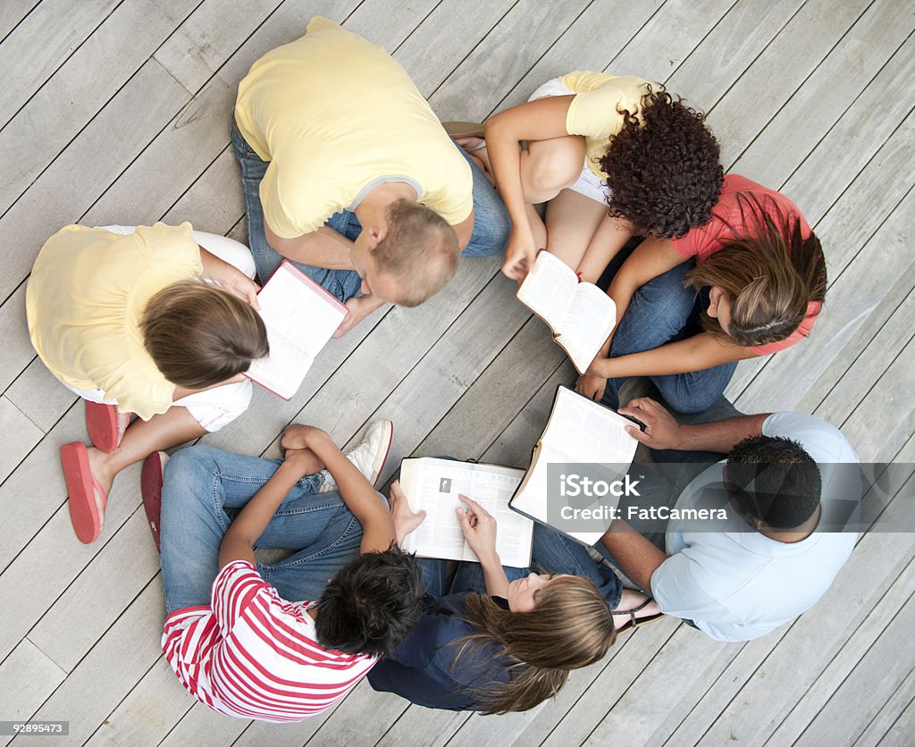 Young adult study a group of young adults studying the Bible together  Bible Stock Photo