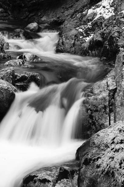 istock river waterfalls with rocks in long exposure in black and white 928956418