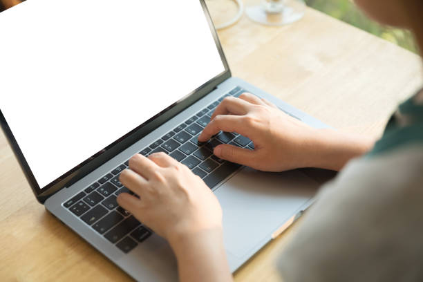 istock Women using laptop with blank screen at table in the office. 928956866