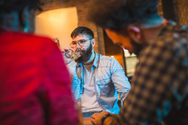 istock Cheerful group of people having fun in the pub 928962720