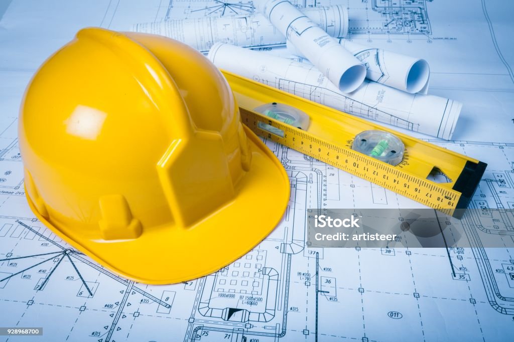 Architect. Yellow helmet with equipment on background Safety Stock Photo