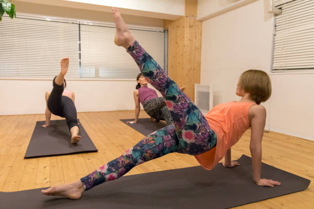 istock Women exercising in Yoga class 928973850
