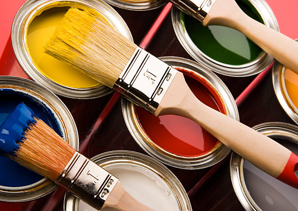 istock Paint brushes dipped in paint and placed on the cans 92897874