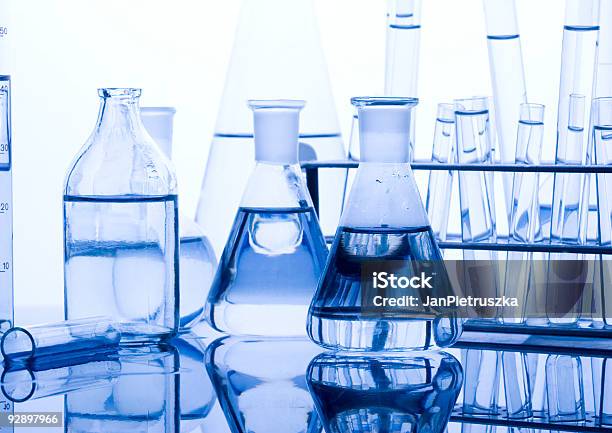 Glassware Laid Out On A Table In A Laboratory Stock Photo - Download Image Now - Acid, Beaker, Biochemistry